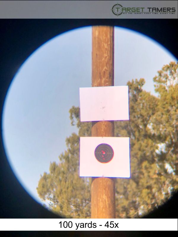 Photo of bullet groupings at 100 yards taken through Carson spotter at 45x