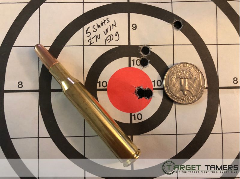 Paper target showing bullet holes & bullet