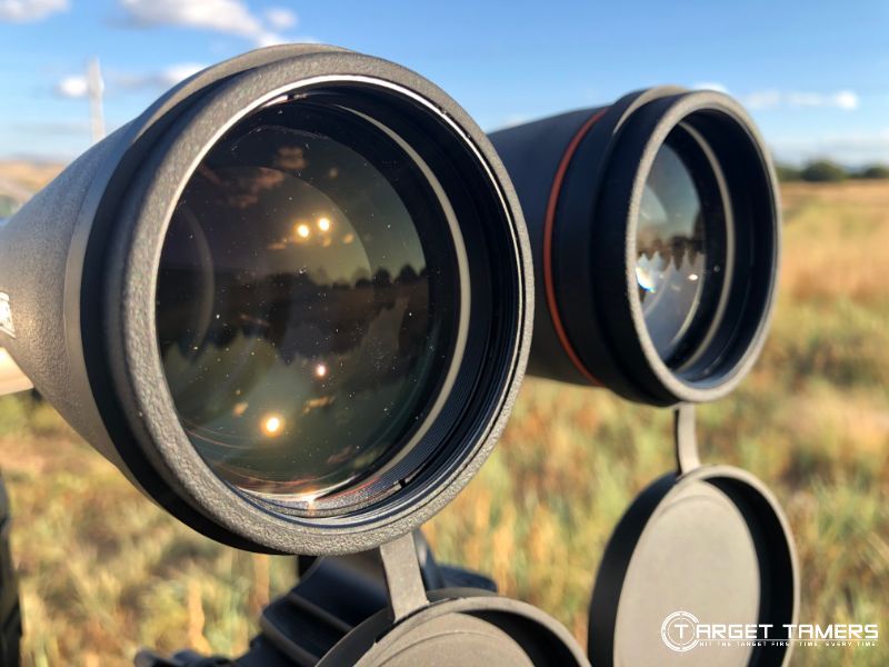 Objective lenses of B.5 15x56 binoculars mounted to tripod