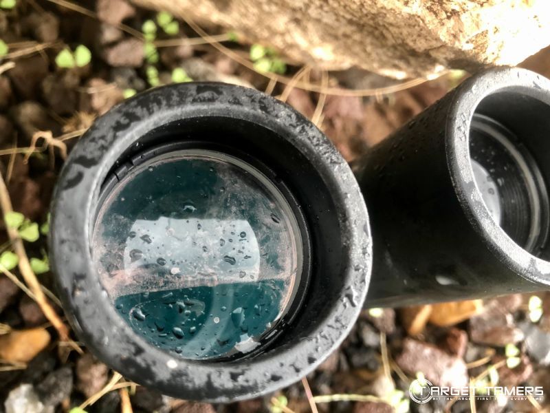 Dirty binocular lenses with water on inside and outside of lenses