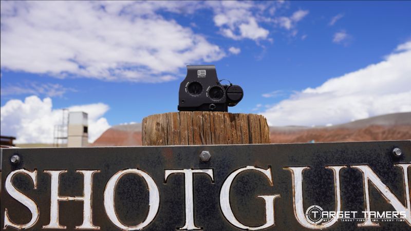 Holographic sight sitting on a shotgun sign